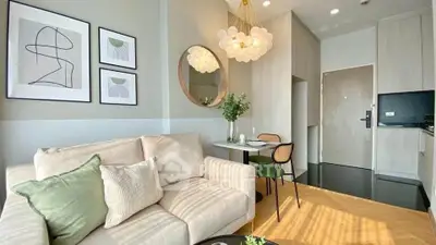 Stylish modern living room with cozy seating and elegant decor in a contemporary apartment.