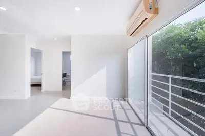 Bright modern living room with large windows and balcony access