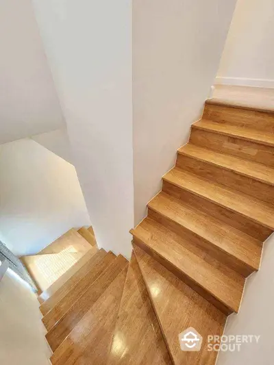 Elegant wooden staircase with natural light in modern home