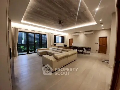 Luxurious modern living room with elegant lighting and spacious seating area.