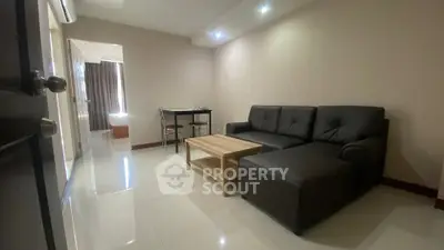 Modern living room with sleek black sofa and minimalist decor