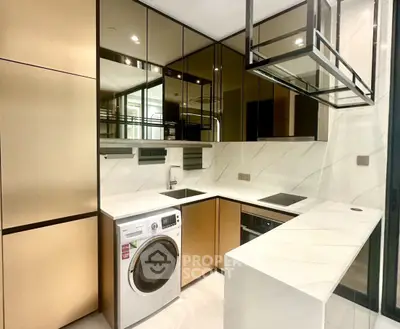 Modern kitchen with sleek design, featuring built-in appliances and elegant marble countertops.