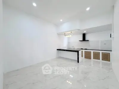 Modern minimalist kitchen with sleek marble flooring and open layout design.