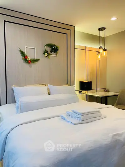 Elegant bedroom with modern decor and cozy lighting, perfect for relaxation and comfort.