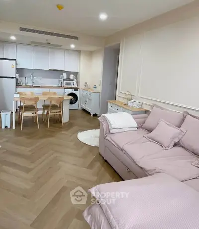 Chic modern living room with open kitchen, featuring stylish furniture and appliances in a cozy apartment.