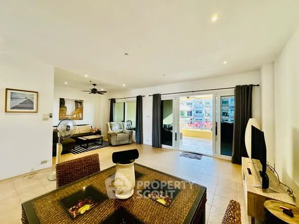 Spacious living room with modern decor and balcony access in a bright apartment.