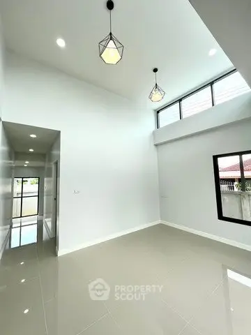 Spacious modern living room with high ceilings and elegant lighting