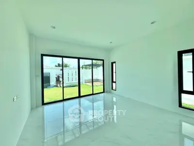 Spacious modern living room with large windows and garden view