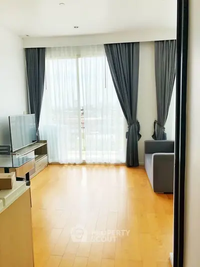 Bright living room with large windows and modern furnishings in a stylish apartment.