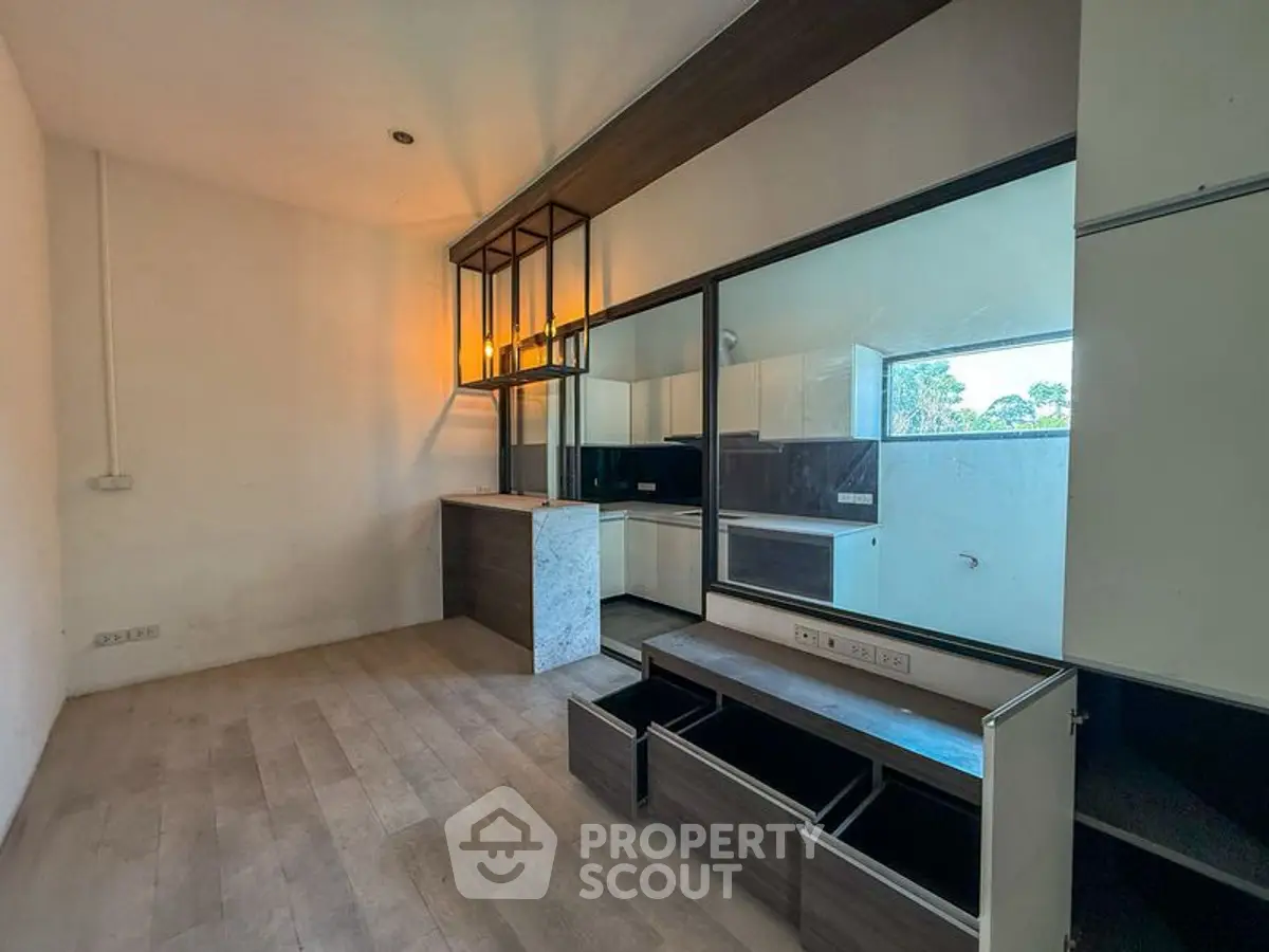 Modern kitchen with sleek cabinetry and open layout, featuring ample storage and natural light.