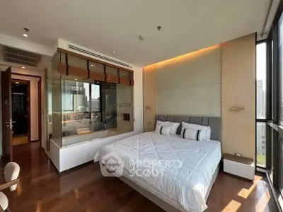 Luxurious bedroom with city view, featuring modern design and large windows for natural light.