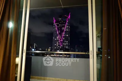 Stunning city view from a modern balcony with illuminated skyscraper