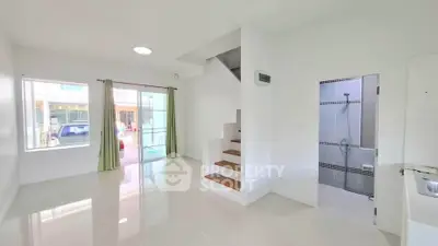 Bright and spacious living area with staircase and shower room, perfect for modern living.