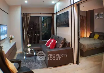 Modern living room with city view and cozy bedroom in open layout apartment.