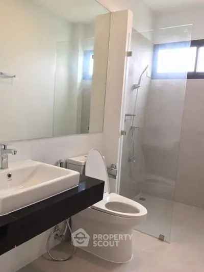 Modern bathroom with glass shower and sleek fixtures