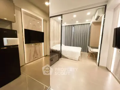 Modern studio apartment with sleek design, featuring a cozy bedroom and stylish living area.