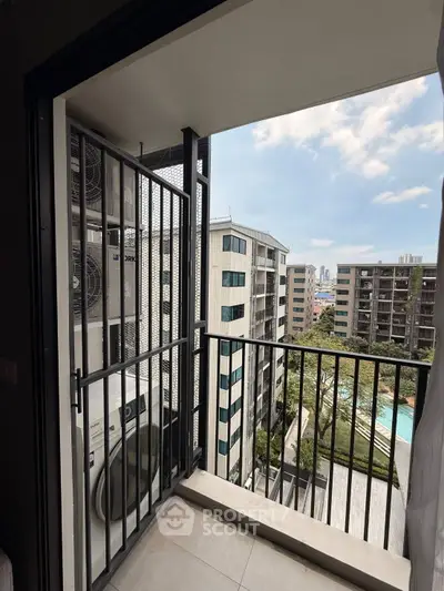 Modern balcony view with cityscape and pool, perfect for urban living.