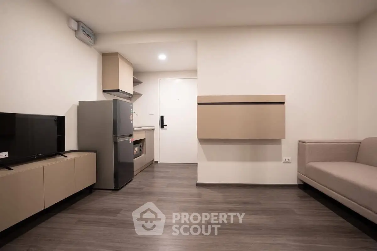 Modern living room with sleek furniture and compact kitchen area