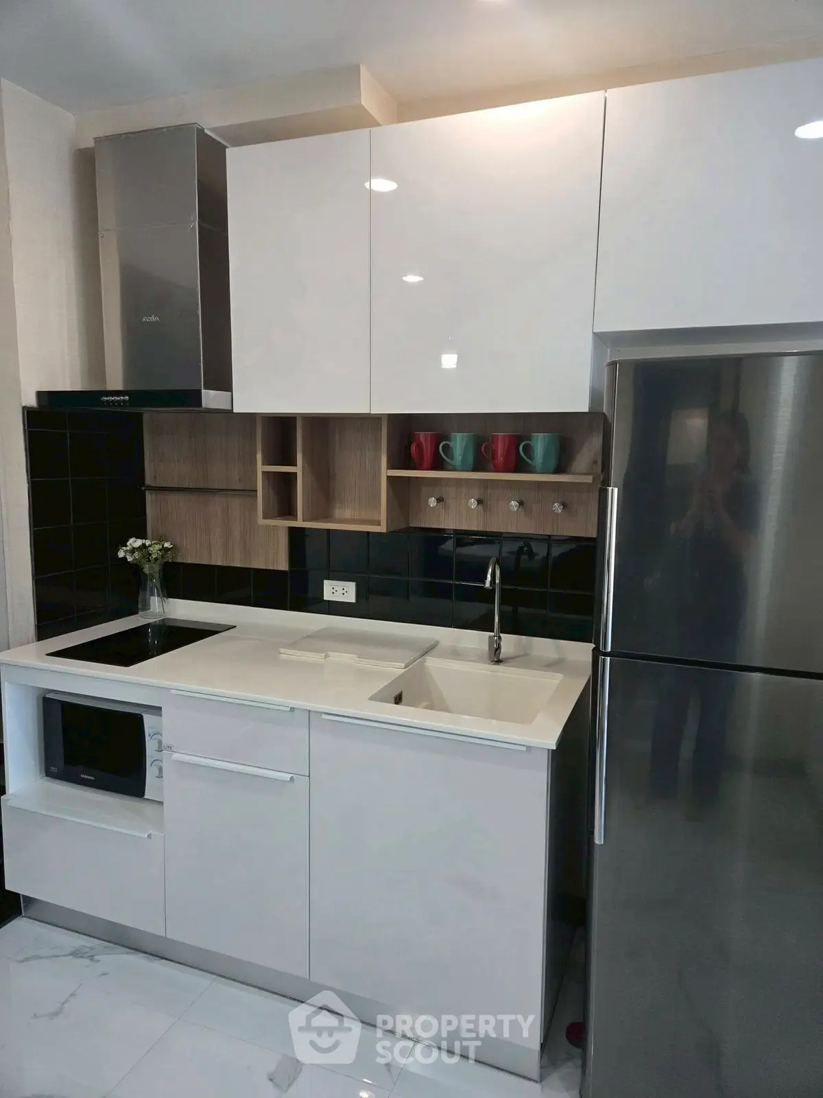 Modern kitchen with sleek cabinets, built-in appliances, and stylish backsplash.