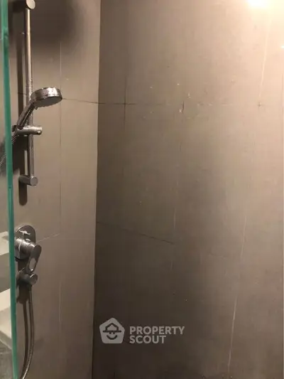 Modern bathroom shower with sleek tile design and chrome fixtures.