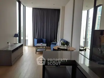Modern living room with floor-to-ceiling windows and stylish furniture in a high-rise apartment.