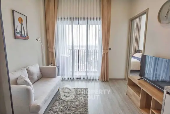 Modern living room with cozy sofa, large window, and stylish decor in a contemporary apartment.