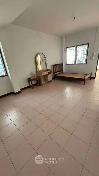 Spacious unfurnished room with tiled flooring and large windows