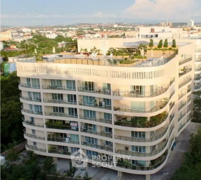 Stunning modern apartment building with rooftop garden and panoramic city views.