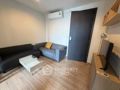 Modern living room with sleek furniture and wooden flooring