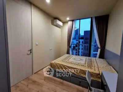 Modern bedroom with city view, featuring a cozy bed and stylish decor.
