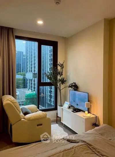 Cozy bedroom with city view, modern decor, and comfortable seating area.