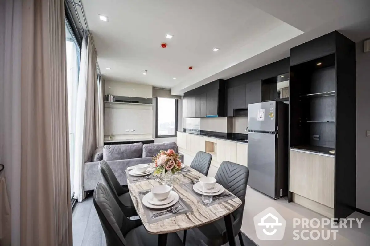 Modern open-layout kitchen and dining area with sleek design and natural light.