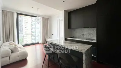 Modern open-layout kitchen and living room with marble island and large window view.