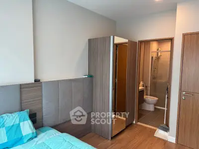 Modern bedroom with ensuite bathroom and stylish wooden furniture