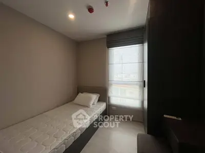 Cozy minimalist bedroom with single bed and natural light