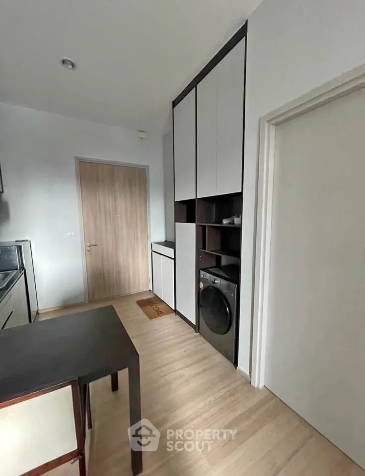 Modern kitchen with sleek cabinetry and built-in washing machine
