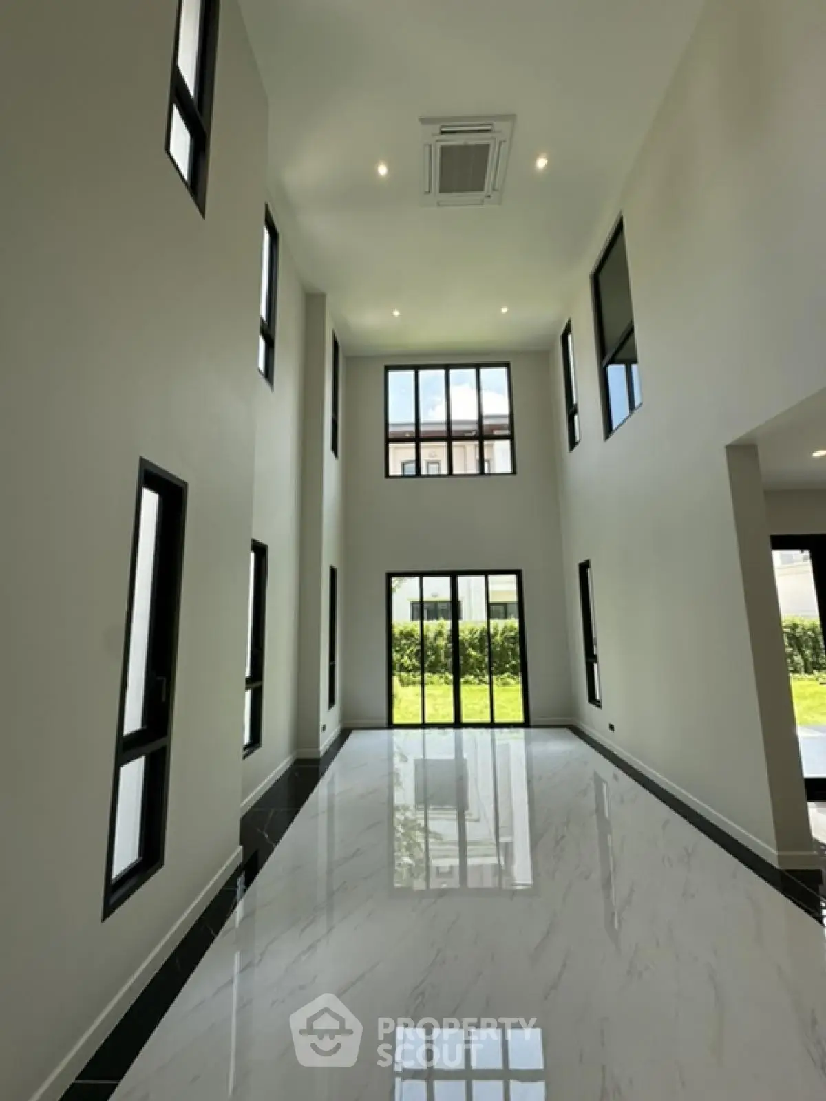 Spacious modern living room with high ceilings and large windows