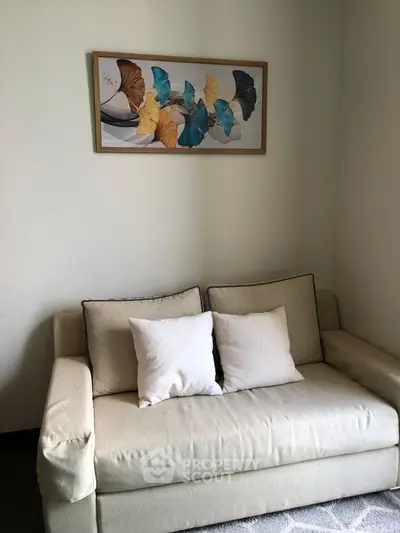 Cozy living room with elegant sofa and artistic butterfly wall art, perfect for relaxation.