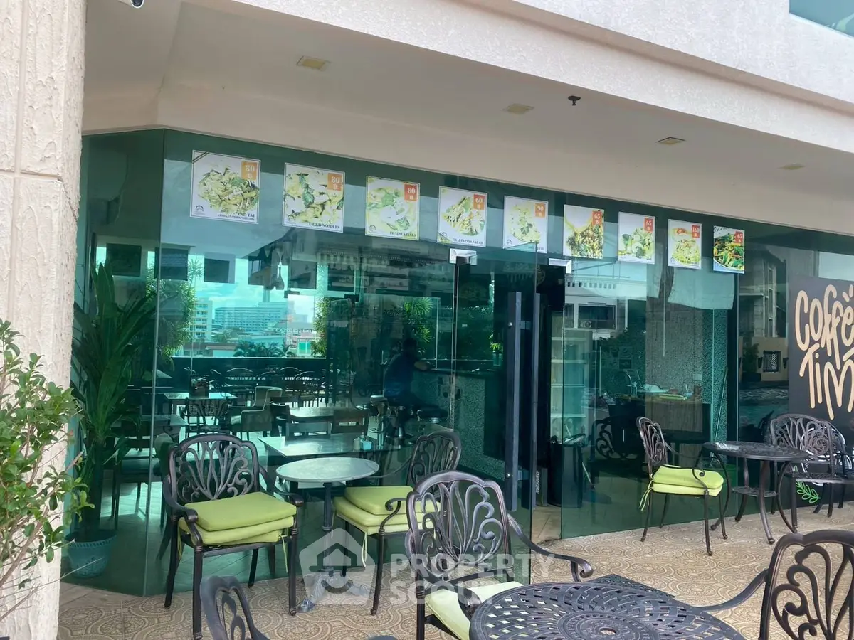 Charming cafe with outdoor seating in a modern building, perfect for relaxation.