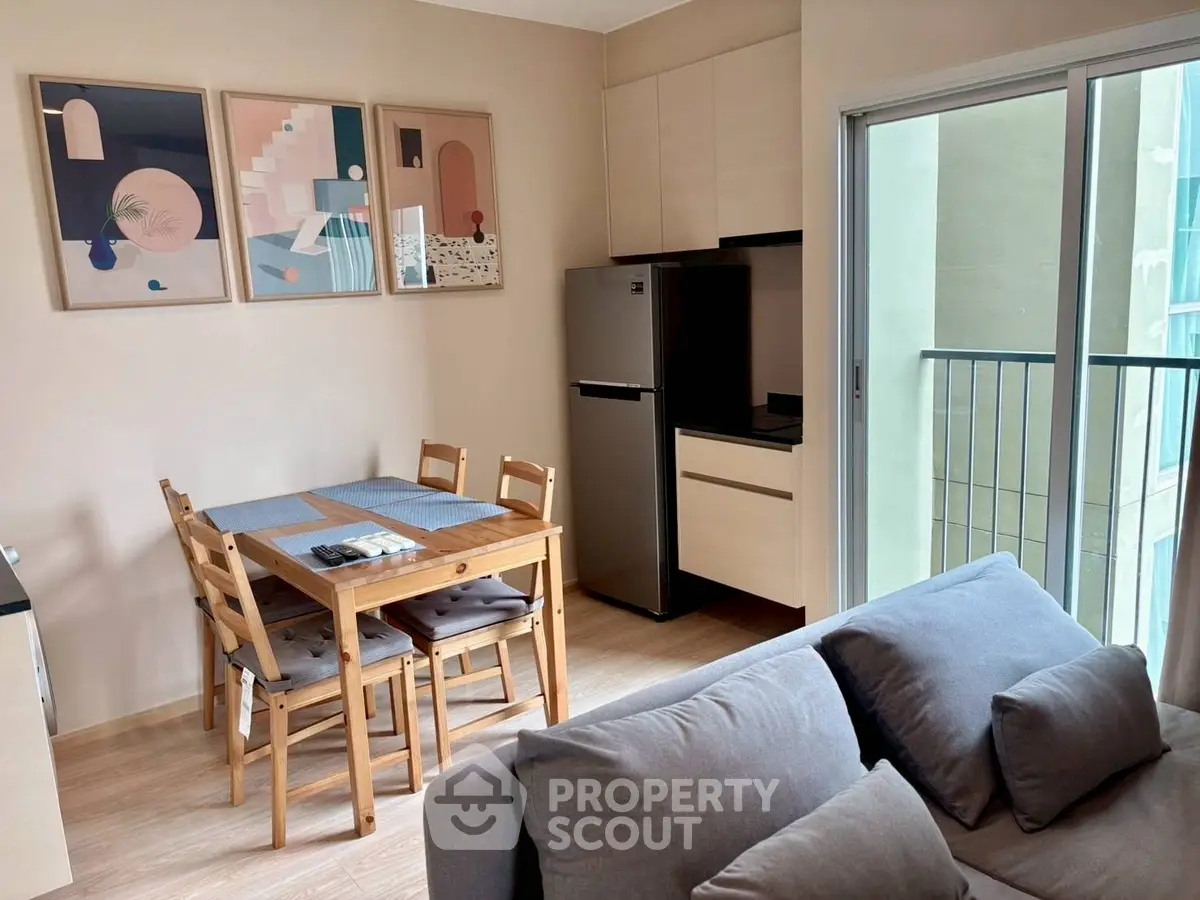 Modern apartment interior with dining area and kitchen, featuring stylish decor and natural light.