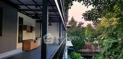 Spacious balcony with outdoor kitchen overlooking lush greenery