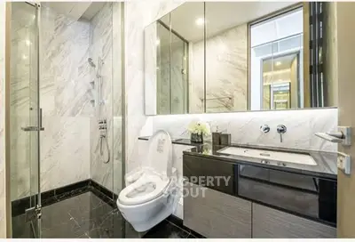 Luxurious modern bathroom with marble walls and sleek fixtures