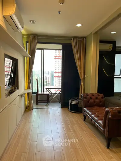 Stylish living room with balcony view in modern apartment