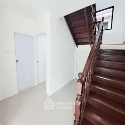 Spacious stairway with elegant wooden railing in modern home