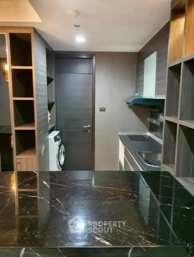 Modern kitchen with sleek black marble countertop and built-in appliances