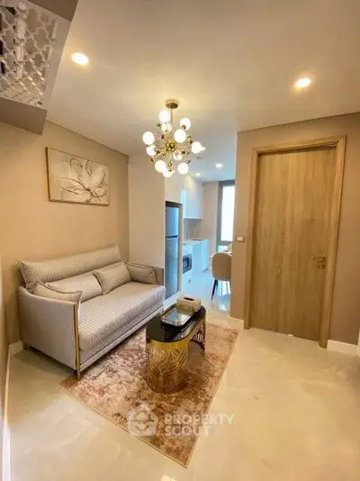 Modern living room with elegant chandelier and cozy sofa in a stylish apartment.