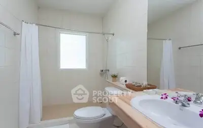 Bright and clean bathroom with modern fixtures and natural light.