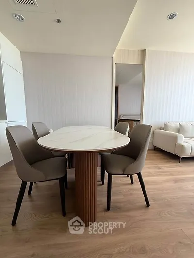 Modern dining area with elegant table and chairs in a stylish living room setting.