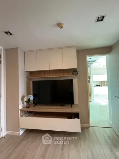 Modern living room with sleek TV unit and wooden flooring