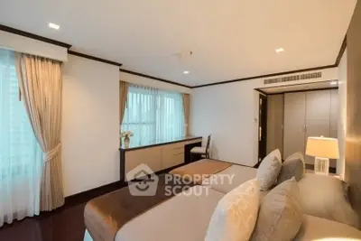 Spacious bedroom with elegant decor and ample natural light